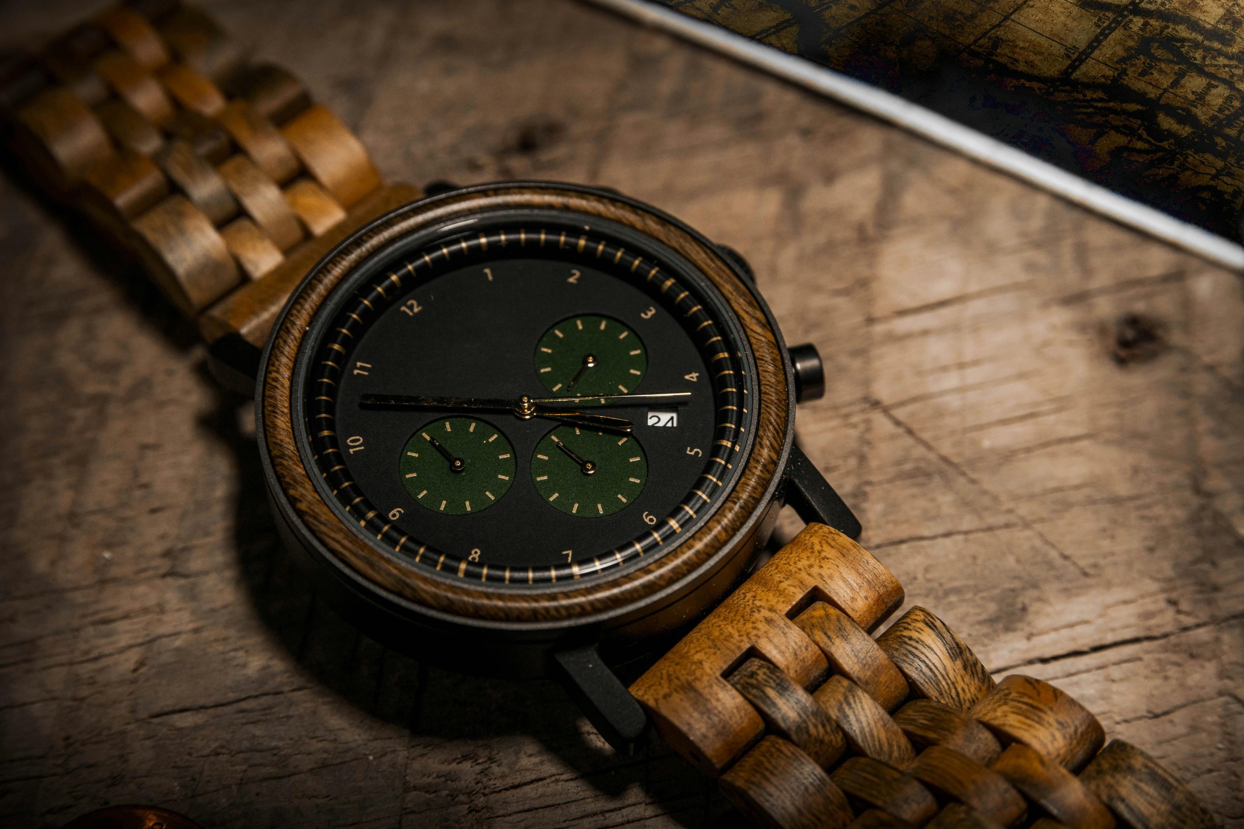 Artistic close-up of a wooden analog wristwatch on a textured surface.